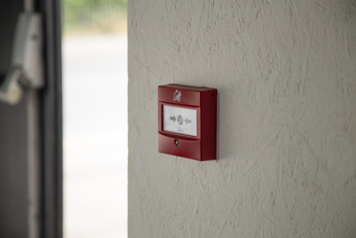 person testing a fire alarm